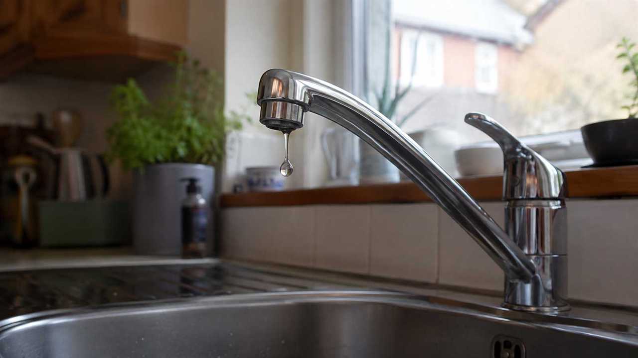 Chrome household tap with a visible droplet at the spout